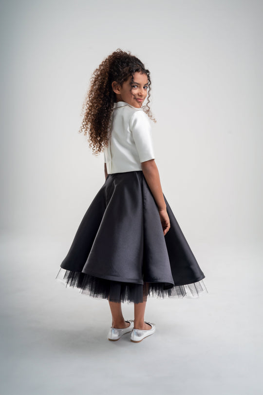 girls white top with black skirt